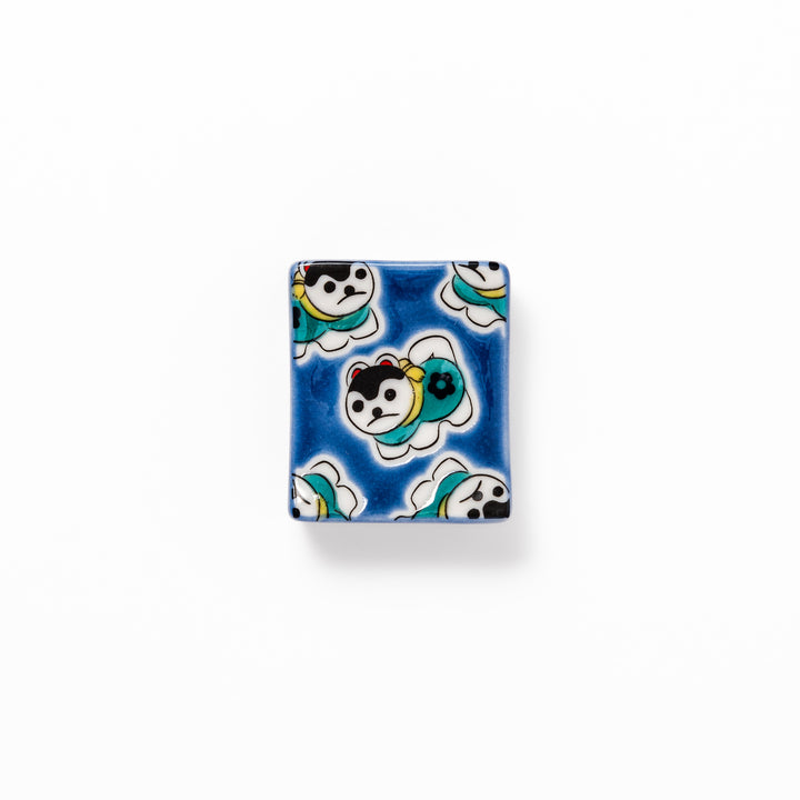 Rectangular Japanese ceramic chopstick rest with a deep blue background decorated with playful lucky dog motifs, bringing charm and fun to dining tables.