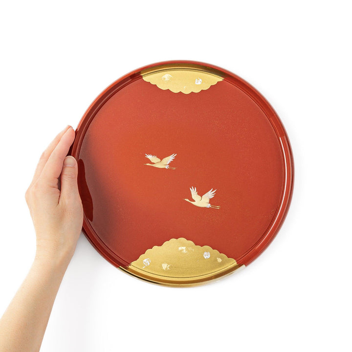 Japanese lacquer serving tray with flying crane motif in gold on red finish elegant round design for traditional table setting