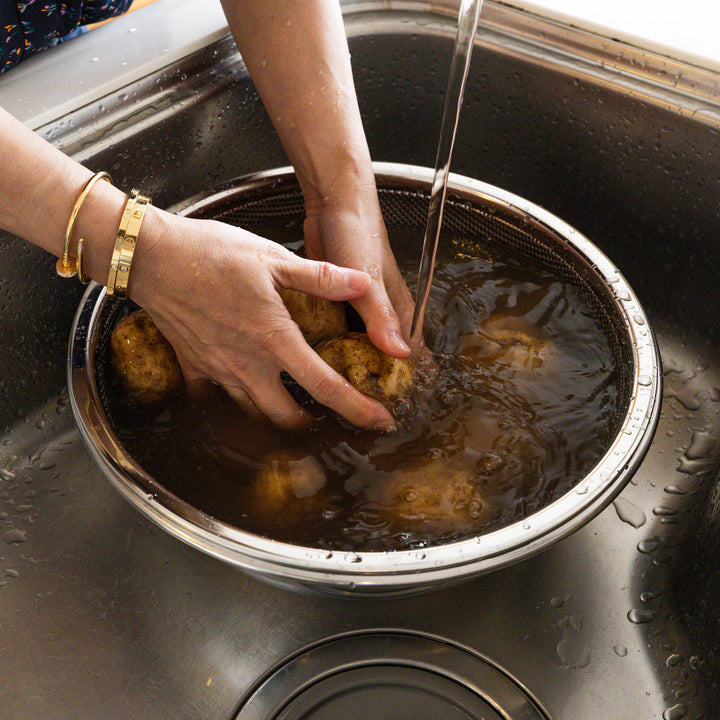 Extra large Japanese stainless steel mixing bowl and strainer, ideal for washing heavy root vegetables in the sink
