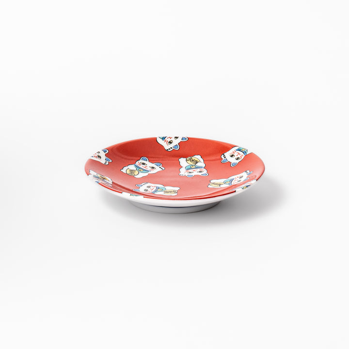 Round Japanese ceramic sauce dish with a red background decorated with playful maneki neko lucky cats, perfect for serving soy sauce or small condiments.