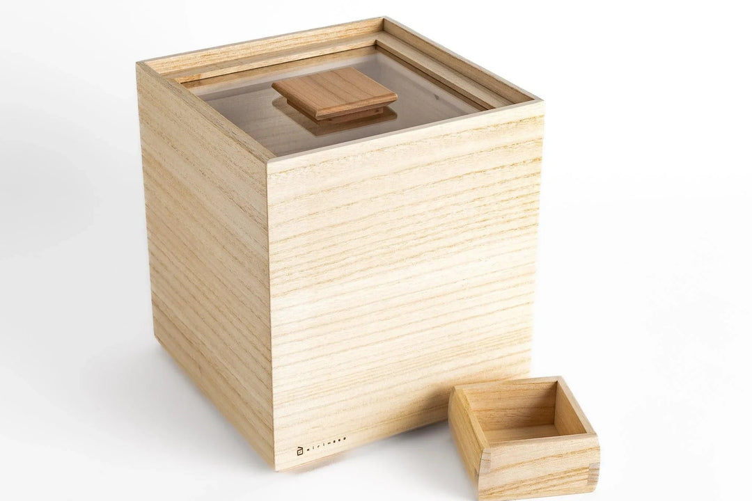 Lightweight kiri wood storage box with sliding lid and small measuring cup displayed on a white background
