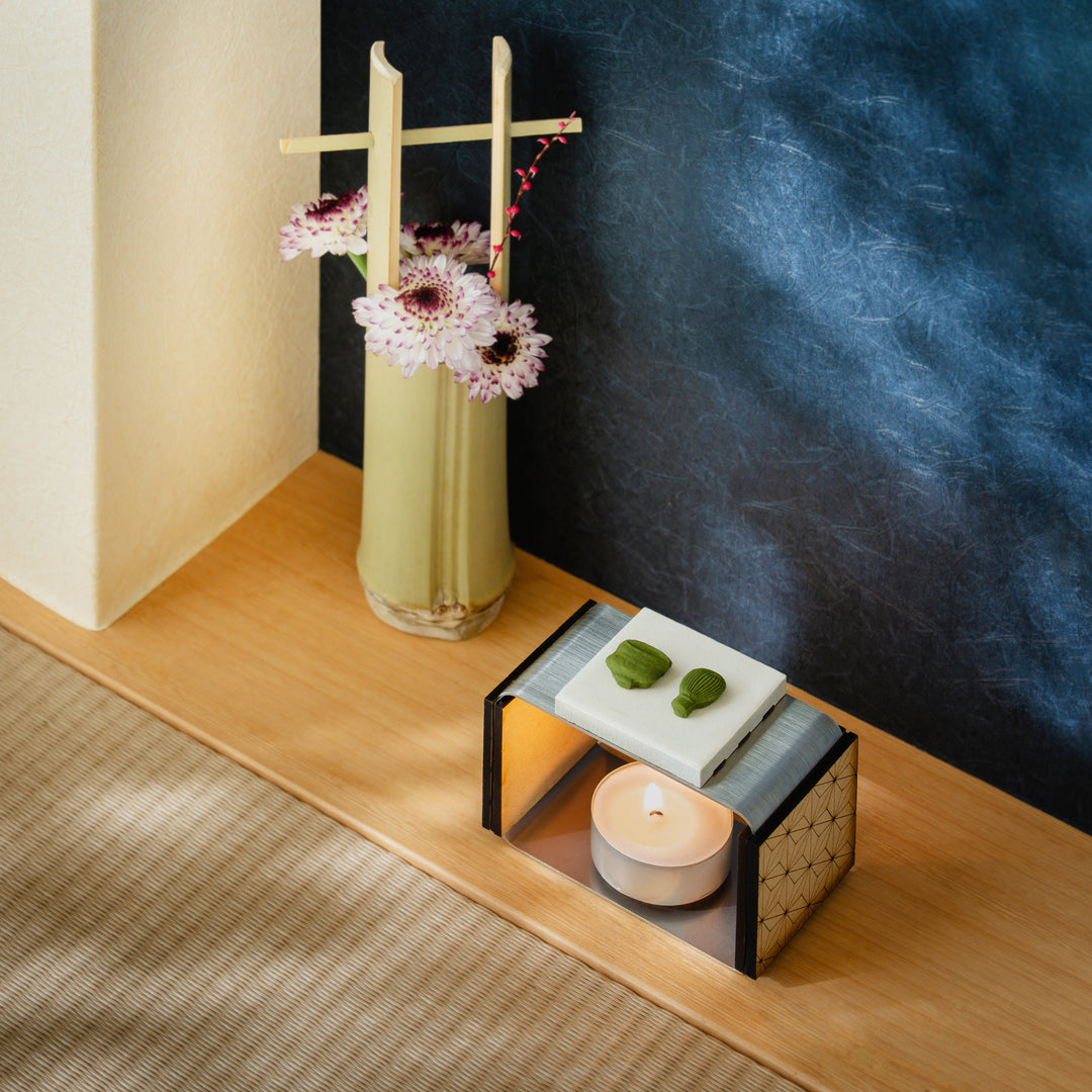 Matcha incense starter set with a ceramic candle warmer displaying tea motif pressed incense in a tatami room