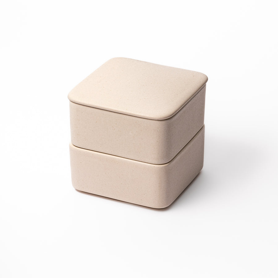 Minimalist white Japanese porcelain bento box set, two-tiered design for elegant meal presentation and versatile storage.