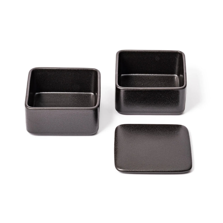Sleek black Japanese porcelain bento box set, two-tiered design for modern, minimalist meal presentation and versatile storage.