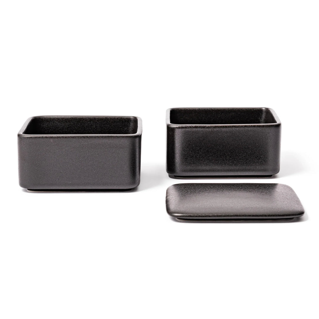 Sleek black Japanese porcelain bento box set, two-tiered design for modern, minimalist meal presentation and versatile storage.