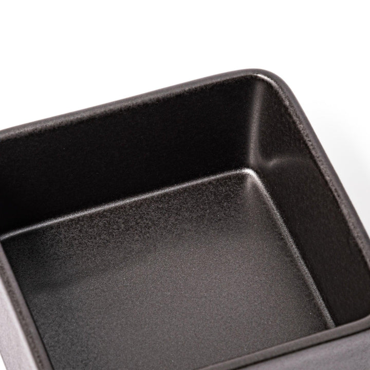 Sleek black Japanese porcelain bento box set, two-tiered design for modern, minimalist meal presentation and versatile storage.