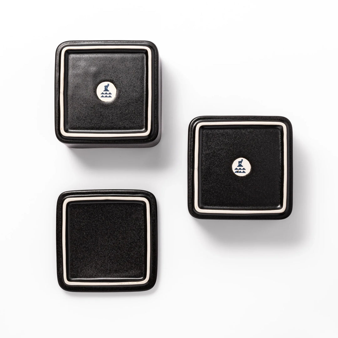 Sleek black Japanese porcelain bento box set, two-tiered design for modern, minimalist meal presentation and versatile storage.