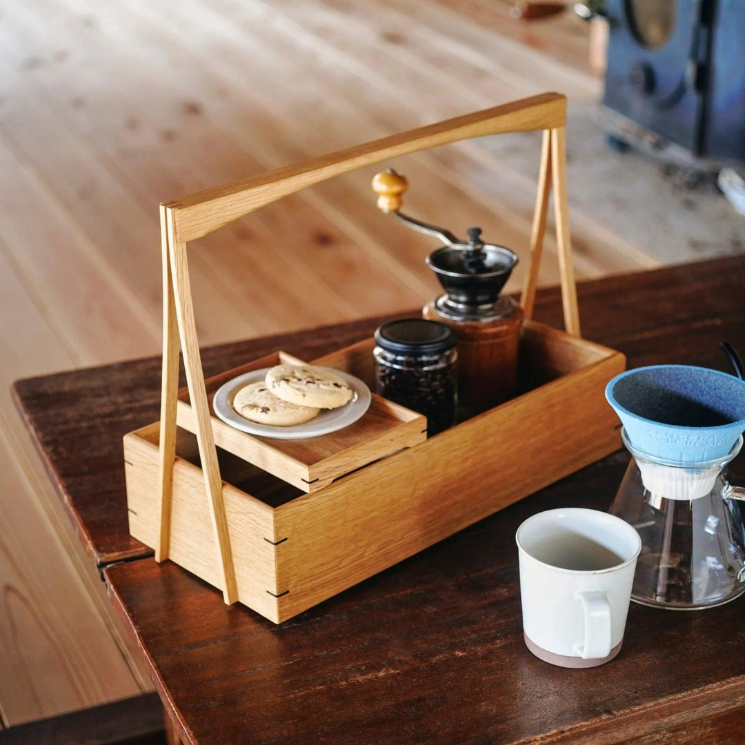 Japanese wooden okamochi storage caddy with removable trays used as coffee station organizer with manual grinder and coffee beans