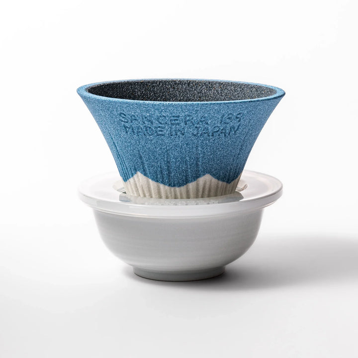 Sky blue Mount Fuji ceramic coffee filter with snowy peak, handcrafted in Japan for reusable pour-over brewing and unique kitchen decor.