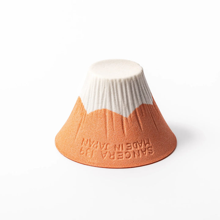 Orange Mount Fuji ceramic coffee filter with snowy peak design, handcrafted in Japan for reusable pour-over brewing and modern kitchen decor.