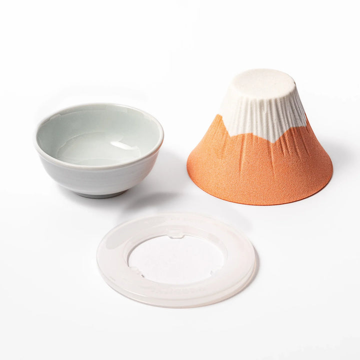 Orange Mount Fuji ceramic coffee filter with snowy peak design, handcrafted in Japan for reusable pour-over brewing and modern kitchen decor.