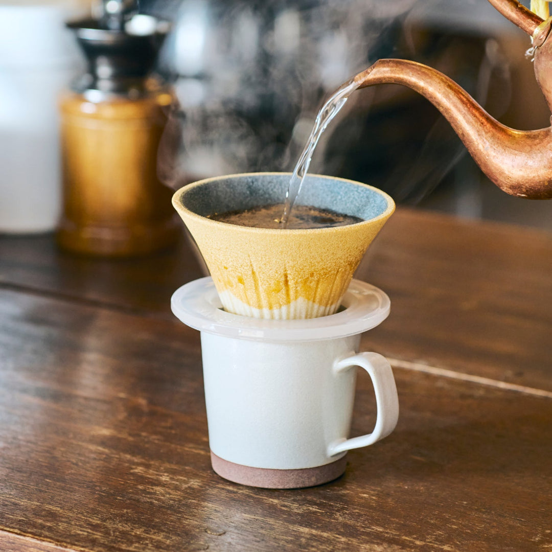 Japanese ceramic coffee filter shaped like Mount Fuji in sunflower yellow, adding brightness and charm to your morning coffee routine.