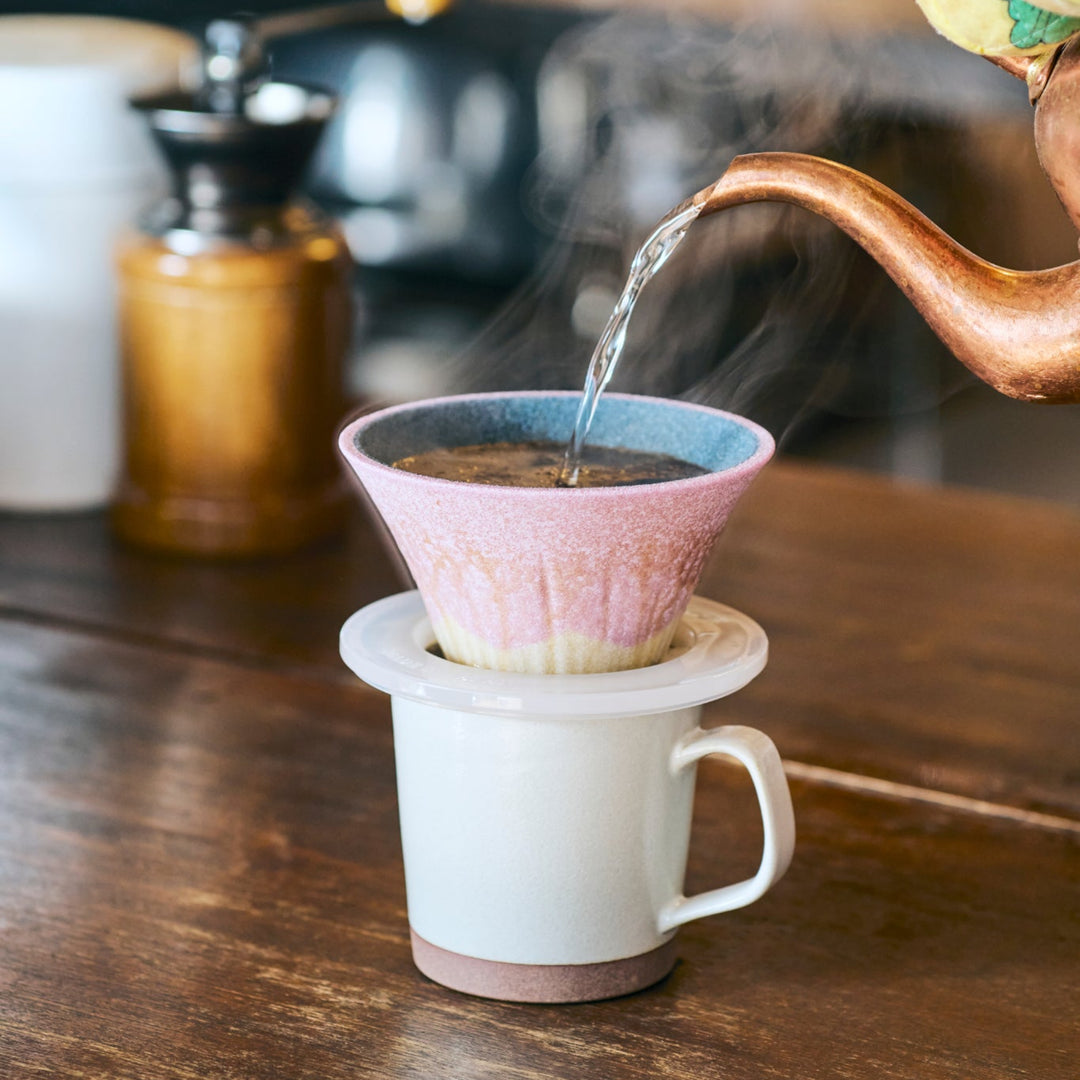 Lavender toned Mount Fuji ceramic coffee filter handcrafted in Japan, creating a serene pour over coffee moment with gentle steam rising.