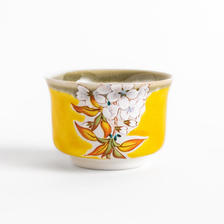 Yellow sake cup with a delicate cherry blossom design, perfectly complementing spring-themed tableware for a vibrant and charming dining experience.