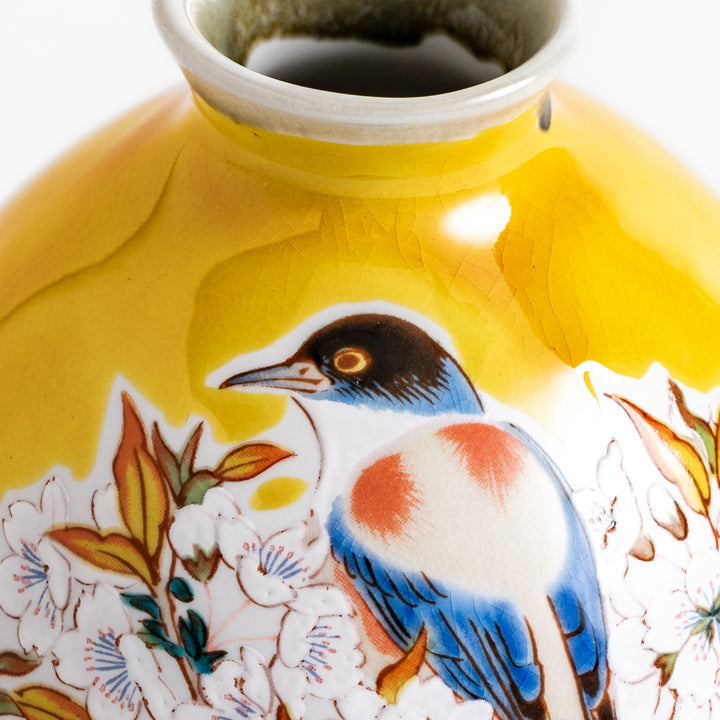 Yellow sake bottle featuring a vibrant cherry blossom and bird design, perfect for adding a touch of spring beauty to your tableware collection.
