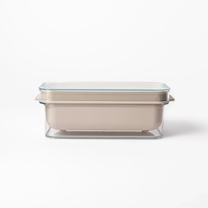 Japanese nukazuke fermentation box with clear lid and black rice paddle for home pickling and storage.