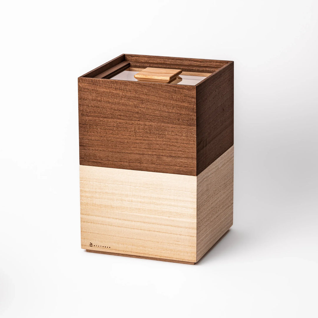 Stackable paulownia wood rice containers in two-tone brown and natural finish, handcrafted in Japan to store rice fresh with space-saving design.