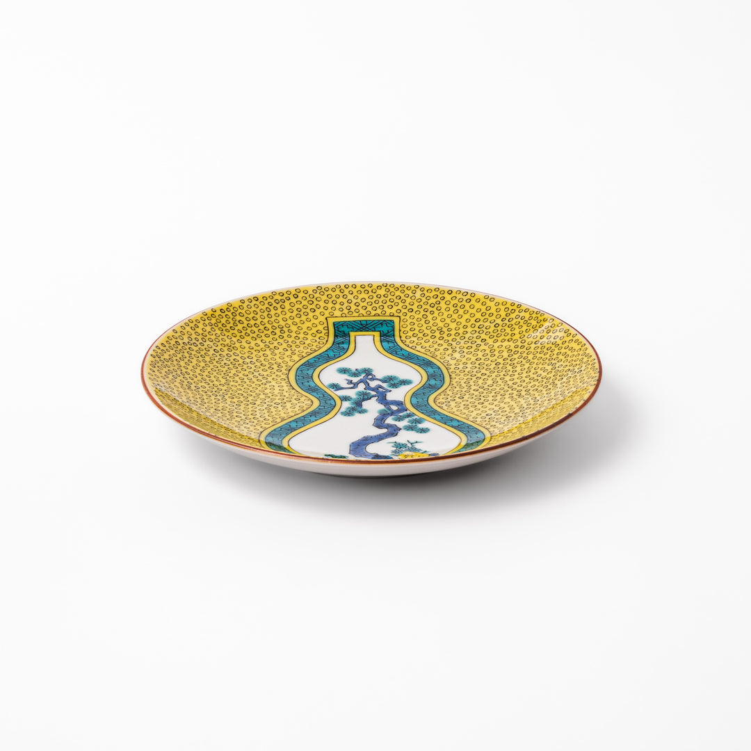 Japanese dessert plate featuring a yellow patterned background with a gourd-shaped center, showcasing a blue pine tree and green foliage.