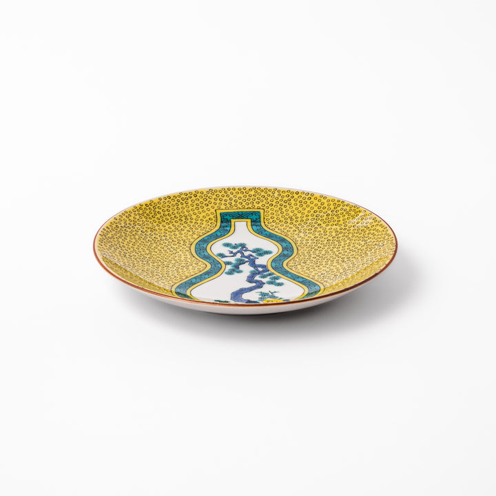 Japanese dessert plate featuring a yellow patterned background with a gourd-shaped center, showcasing a blue pine tree and green foliage.