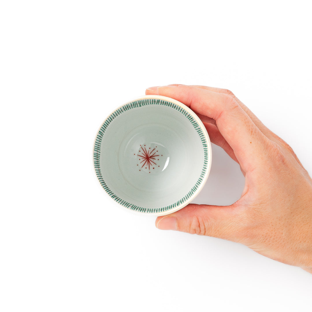 Japanese ceramic tea cup with plum petal stripe design in green, blending modern simplicity with traditional Japanese elegance