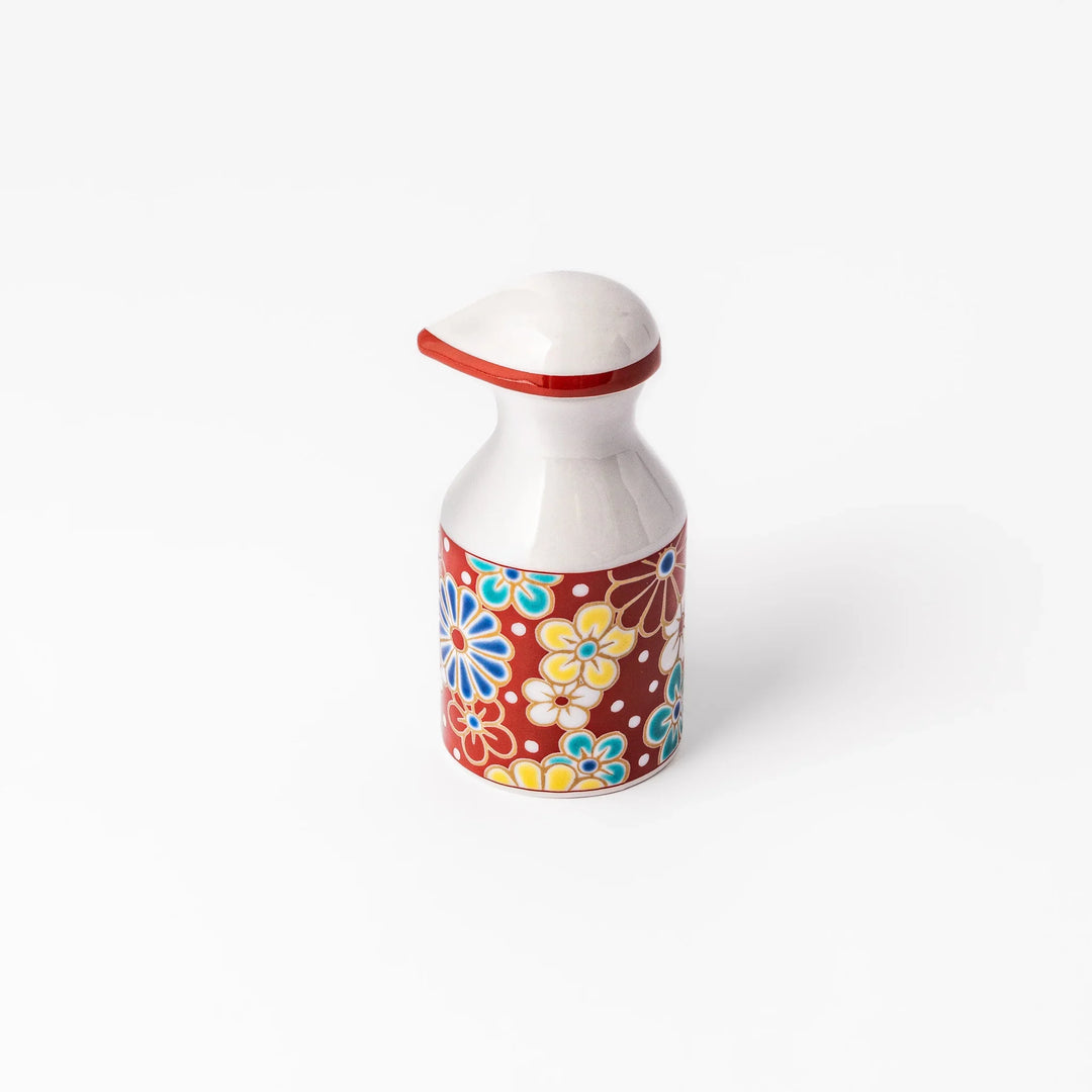 Japanese porcelain soy sauce dispenser with red floral pattern featuring plum and chrysanthemum blossoms, handcrafted design.