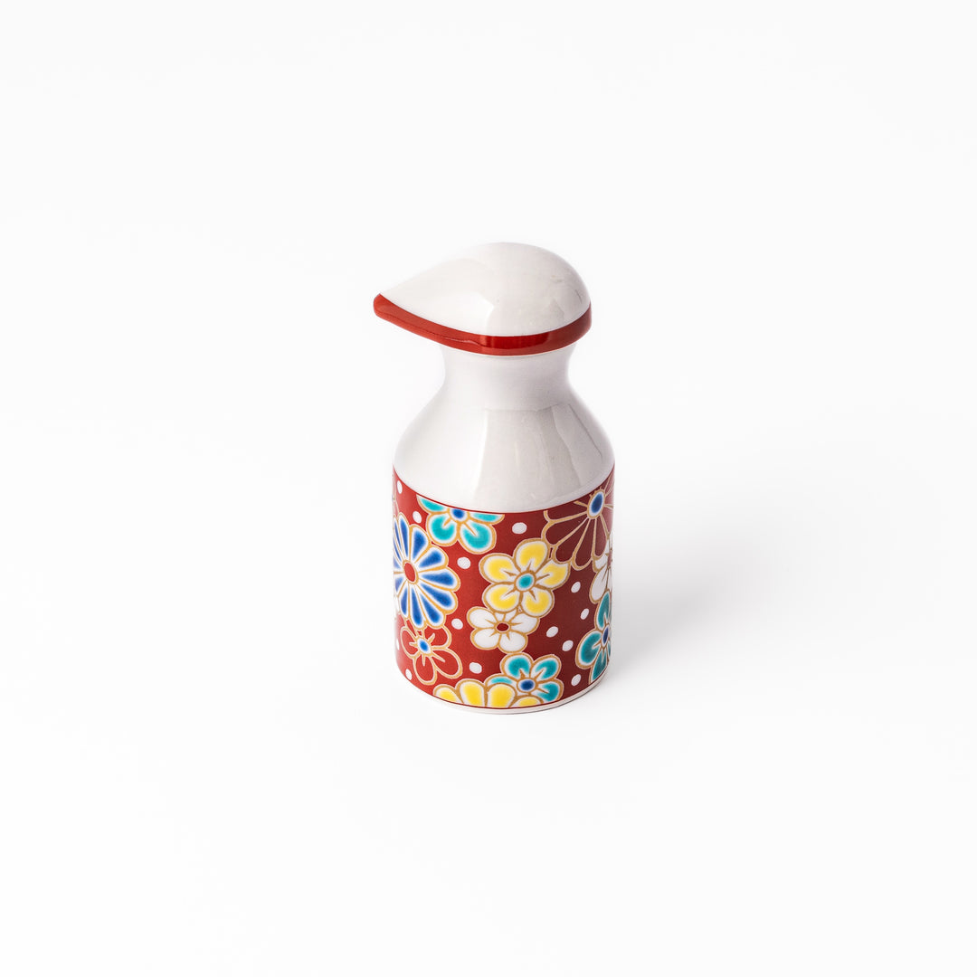Japanese ceramic soy sauce dispenser with a red lid and colorful plum and chrysanthemum blossom pattern, handcrafted in Arita Japan.