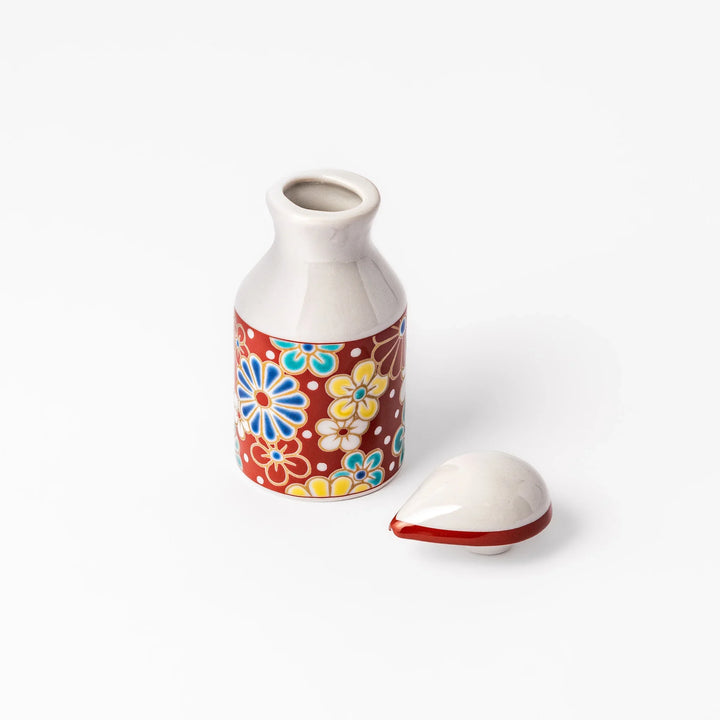 Japanese porcelain soy sauce dispenser with red floral pattern featuring plum and chrysanthemum blossoms, handcrafted design.