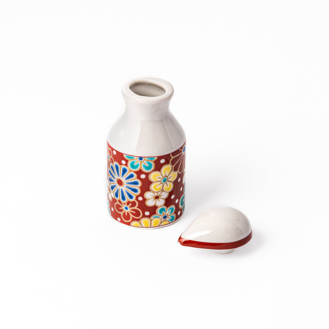Japanese ceramic soy sauce dispenser with a red lid and colorful plum and chrysanthemum blossom pattern, handcrafted in Arita Japan.