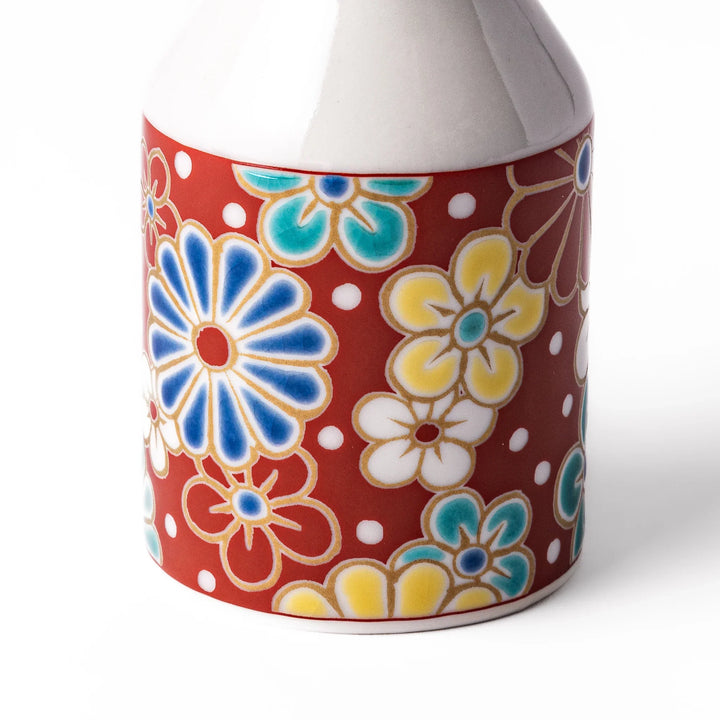 Japanese porcelain soy sauce dispenser with red floral pattern featuring plum and chrysanthemum blossoms, handcrafted design.