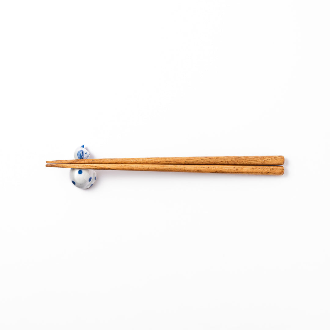Blue polka dot cat-shaped ceramic chopstick rest with a relaxed expression, bringing a whimsical charm to your dining table.