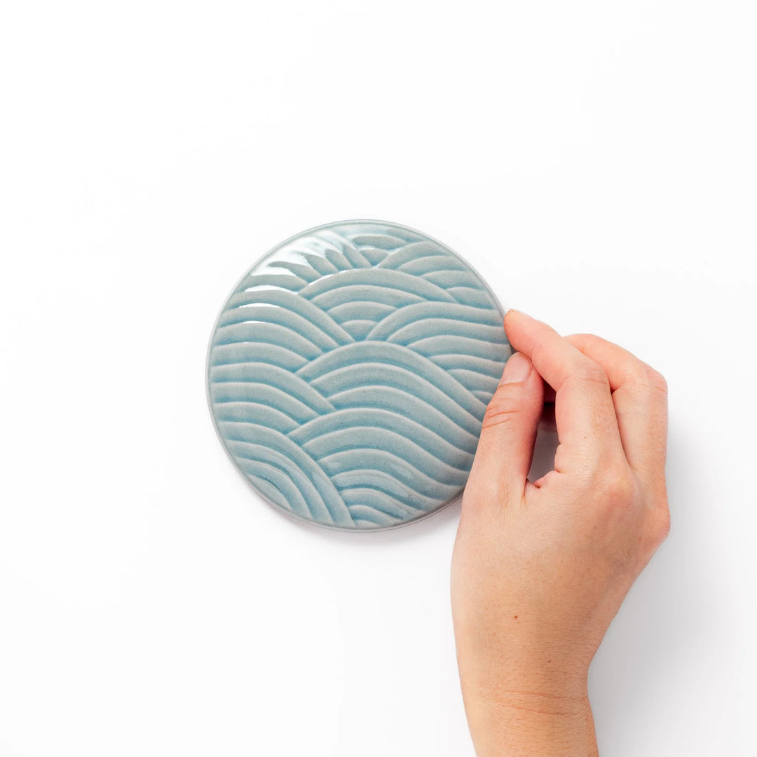 Light blue porcelain lid with embossed Seigaiha wave pattern, crafted to match stackable Japanese bowls beautifully.