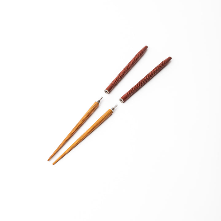 Red Japanese travel chopsticks unscrewed into two parts to demonstrate the portable design and durable metal joints