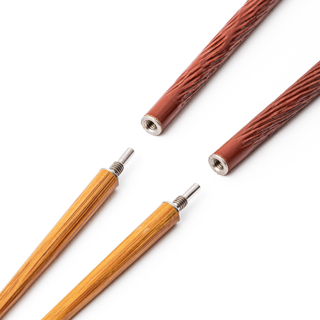 Red Japanese travel chopsticks unscrewed into two parts to demonstrate the portable design and durable metal joints