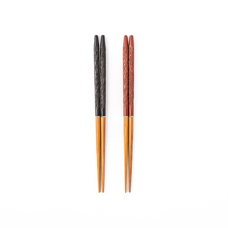 Two pairs of portable Japanese travel chopsticks in black and red showing the detailed textured handles and natural wood tips