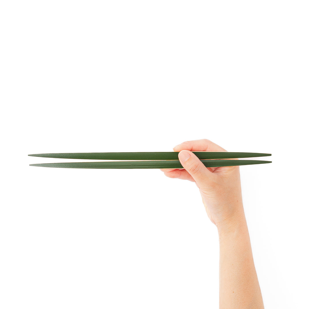 A pair of precision Japanese bamboo cooking chopsticks featuring slim green handles and ultra fine tapered tips for delicate plating