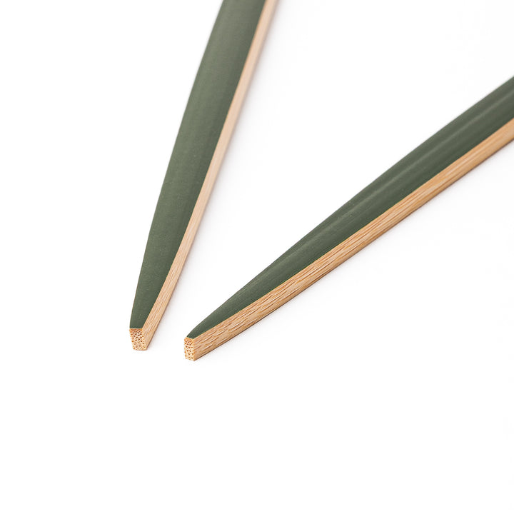 A pair of precision Japanese bamboo cooking chopsticks featuring slim green handles and ultra fine tapered tips for delicate plating