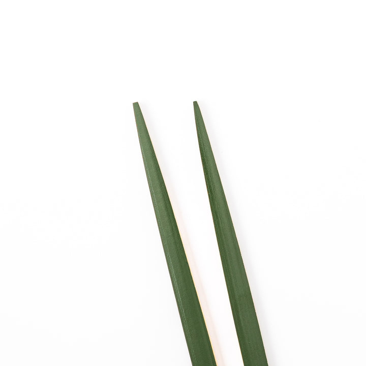 A pair of precision Japanese bamboo cooking chopsticks featuring slim green handles and ultra fine tapered tips for delicate plating