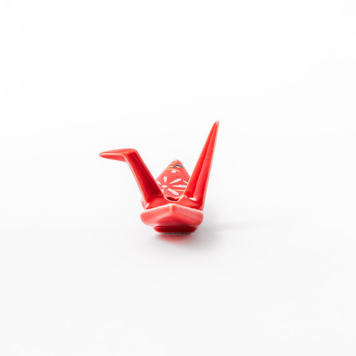 Red ceramic origami crane incense holder with delicate floral details, blending Japanese tradition and modern tableware design