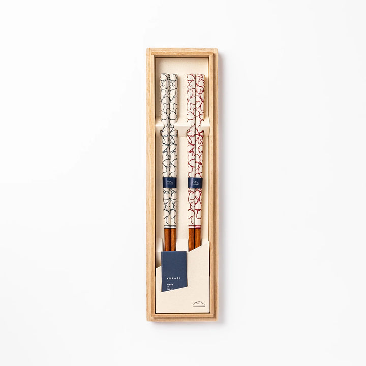 Red and blue Sakura Japanese chopsticks gift set with cherry blossom pattern handles in a wooden presentation box.
