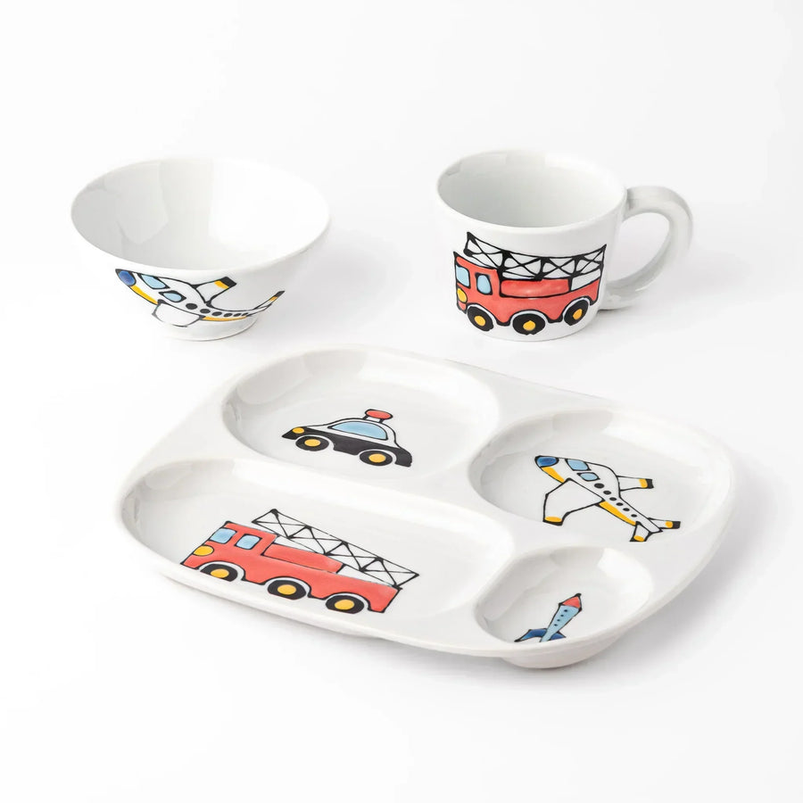 White ceramic kids mug, plate, and rice bowl set featuring fire truck, police car, airplane, and rocket graphics