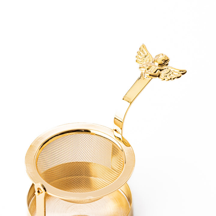 Elegant Japanese rotating gold angel tea strainer with stainless steel mesh basket and drip catcher base