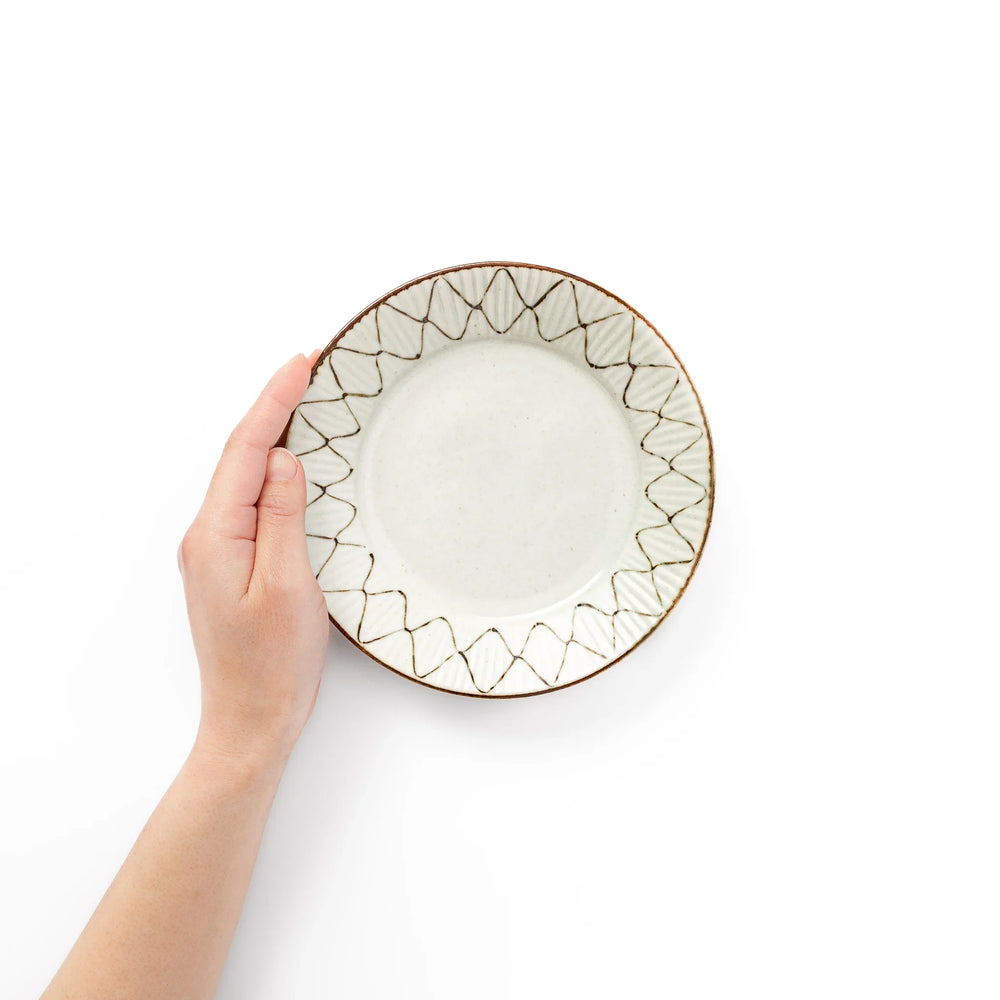 Rustic diamond weave dessert plate shown held in hand