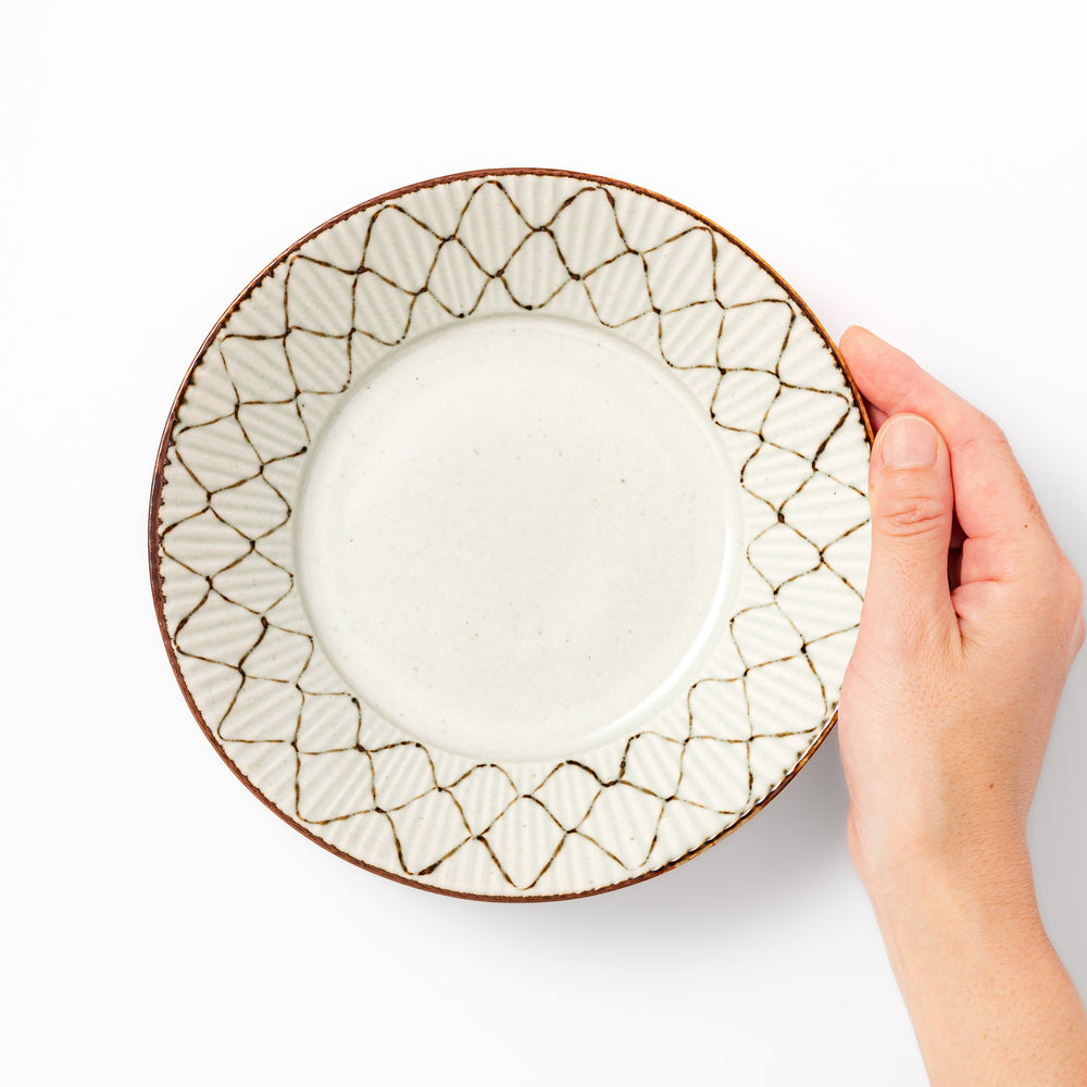 Japanese ceramic pasta bowl with rustic diamond weave pattern, earthy brown rim, and textured design for modern dining