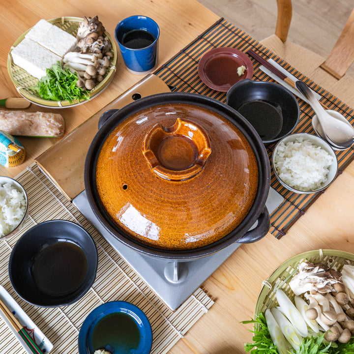 Rustic glaze induction compatible donabe japanese clay pot table setting with fresh hot pot ingredients dinner ware