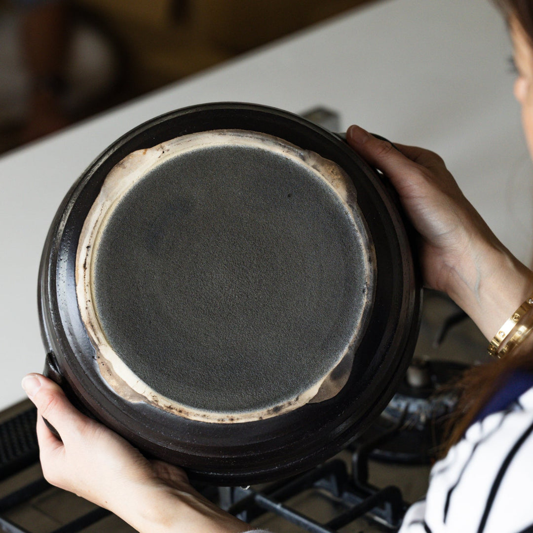 Nami showing flat bottom of rustic glaze induction compatible donabe japanese clay pot cookware for ih stovetop heating