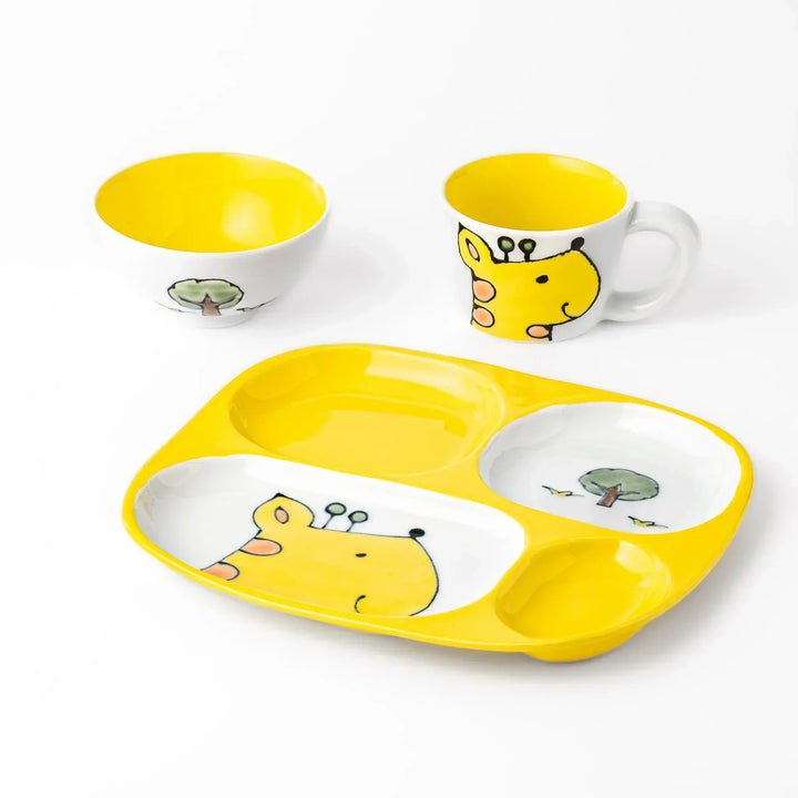 White ceramic kids mug, divided plate and bowl set with smiling yellow giraffe, tree and bird accents, vibrant yellow interior