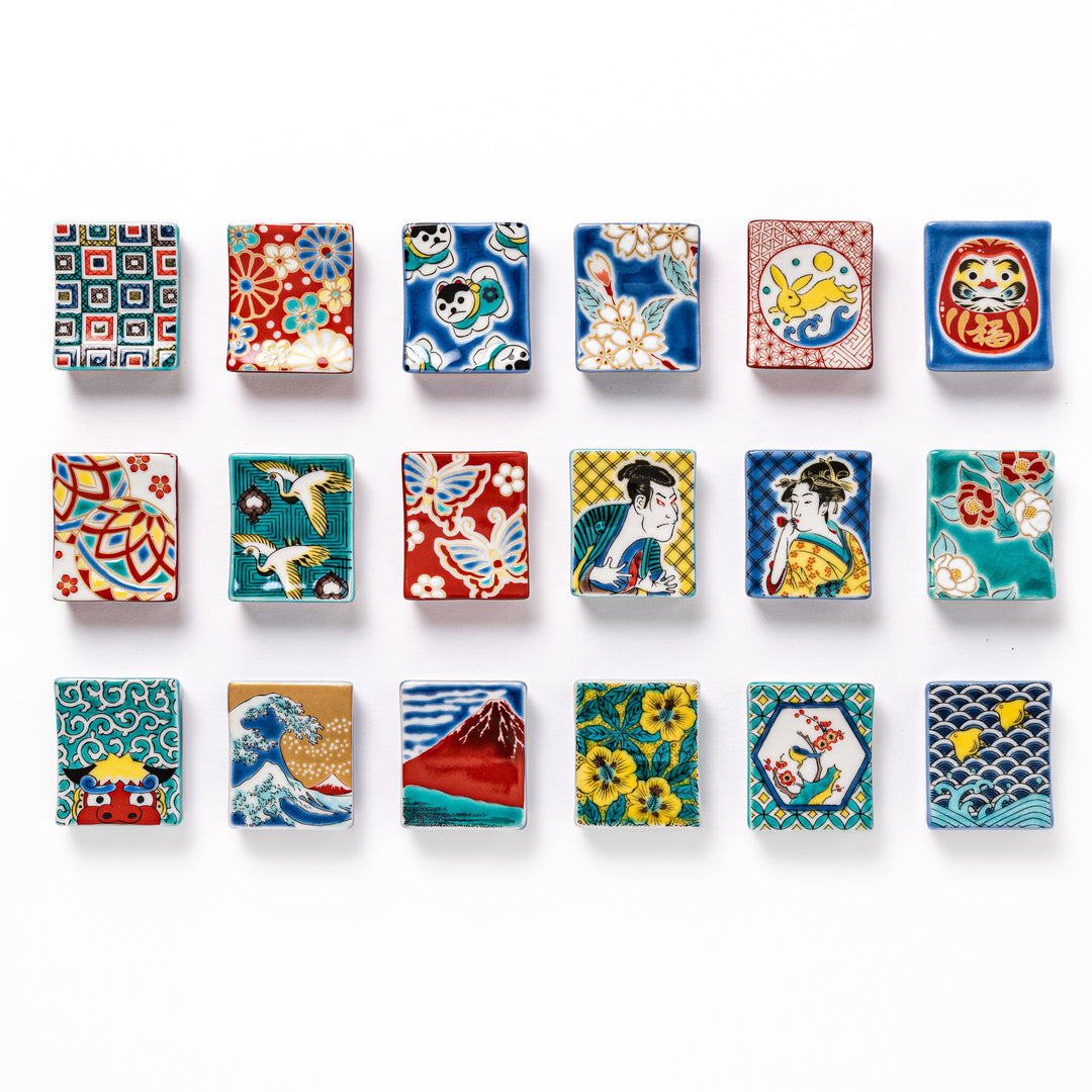 Collection of Japanese ceramic chopstick rests featuring diverse traditional motifs including waves, Mt. Fuji, florals, ukiyo-e figures, animals, and lucky symbols.