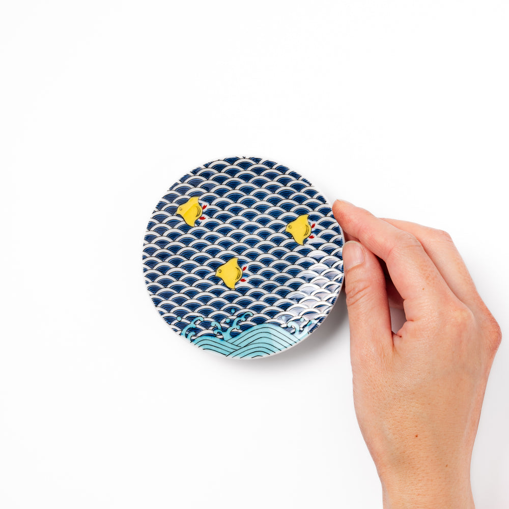 Round Japanese ceramic sauce dish with traditional blue wave pattern and playful yellow shorebirds, perfect for serving soy sauce, condiments, or appetizers.