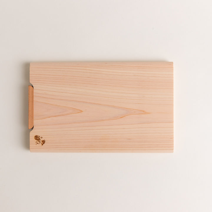 Small Hinoki wood cutting board with smooth grain, natural finish, corner handle, and engraved motif, crafted in Japan