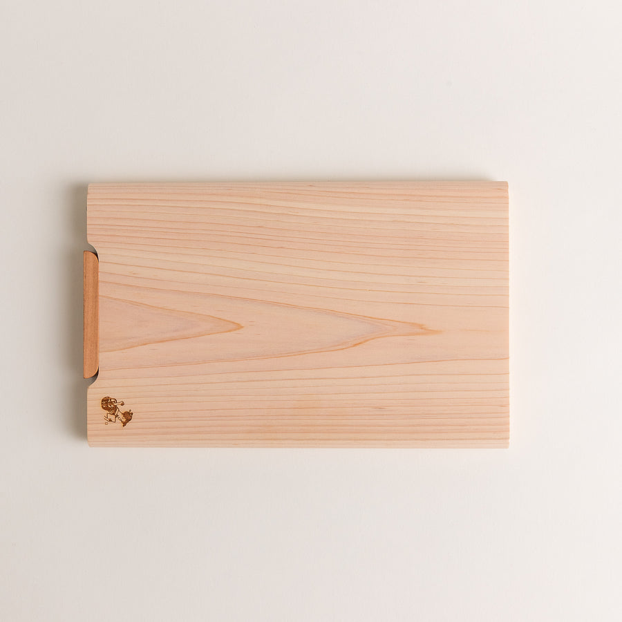 Small Hinoki wood cutting board with smooth grain, natural finish, corner handle, and engraved motif, crafted in Japan